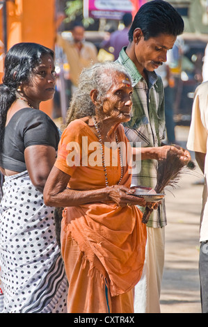 Vertical portrait of a female pilgrim outside the entrance of the Mannarasala Sree Nagaraja Temple in Haripad, Kerala. Stock Photo