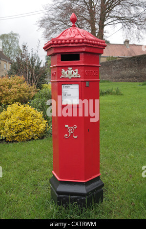 An original bright red Victorian Royal Mail Penfold pillar box (post box) in Tetbury, Gloucestershire, UK Stock Photo