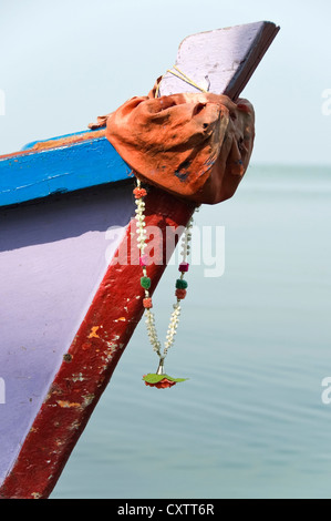 Vertical close up of a colourful garland on the bow of a tour boat in the backwaters of Kerala. Stock Photo