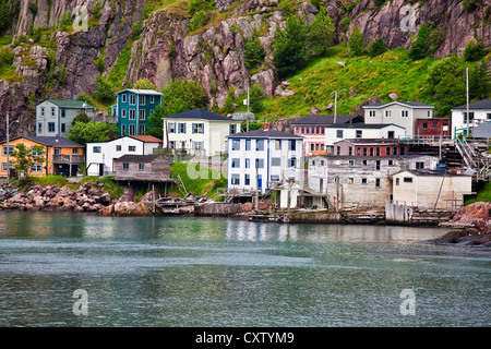 Colorful houses on the rocky shore of Signal Hill facing the harbour in St. John's, Newfoundland, Canada. A section of town know Stock Photo