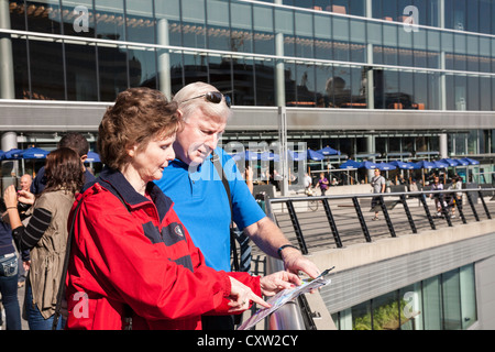 Mature Tourist Couple Checking Map, Vancouver Convention Centre, Vancouver, Canada Stock Photo
