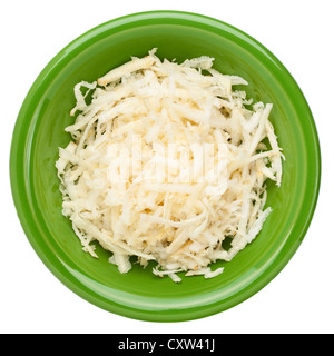 grated celery root (celeriac) on a small green ceramic bowl, isolated on white Stock Photo