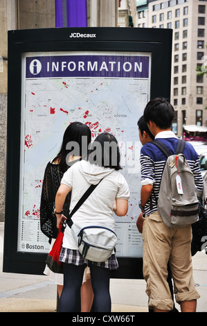 A group of Chinese tourists looking at an information map in Boston, Massachusetts, USA Stock Photo