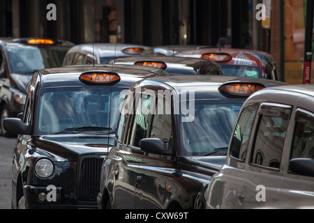 London Taxis Queue - London Black Cabs queue for business in central London UK Stock Photo