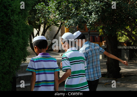 Young Muslim Chinese boys(Huis), in the courtyard of Xining great Mosque, Qinghai province, north west China. Stock Photo