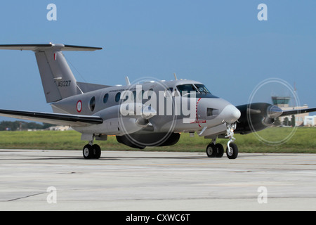 Propeller plane. Beechcraft King Air twin-engine search and rescue airplane of the Armed Forces of Malta taxiing with spinning props. Front view. Stock Photo