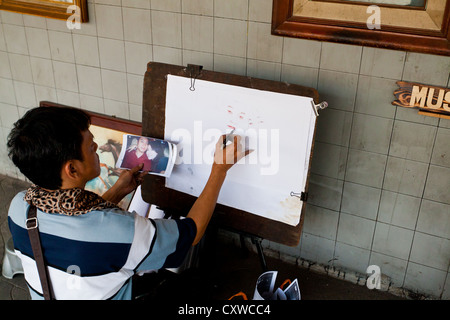 Portrait Artist in the Streets of Jakarta, Indonesia Stock Photo