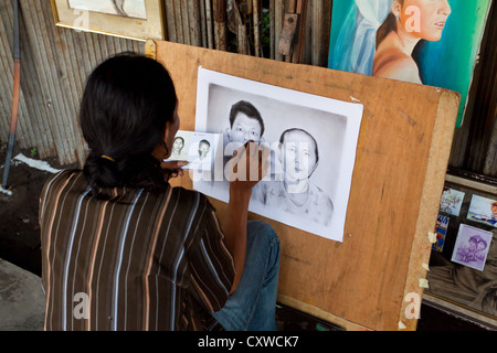 Portrait Artist in the Streets of Jakarta, Indonesia Stock Photo