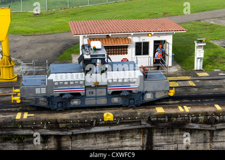 Panama Panama Canal Electric mules or railroad tugs used to guide ships through the locks of the Panama Canal.  These tugs keep the ships aligned by using steel cables to shift the ships within the lock. Stock Photo