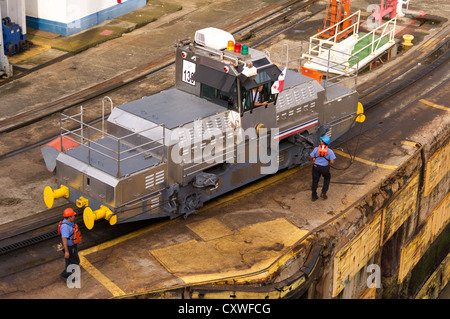 Panama Panama Canal Electric mules or railroad tugs used to guide ships through the locks of the Panama Canal.  These tugs keep the ships aligned by using steel cables to shift the ships within the lock. Stock Photo