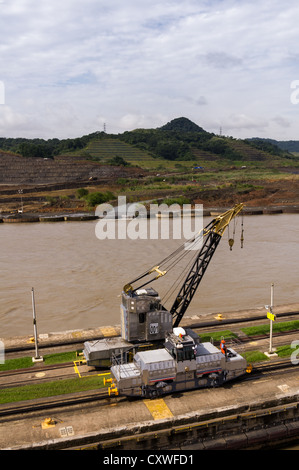 Panama Panama Canal Electric mules or railroad tugs used to guide ships through the locks of the Panama Canal.  These tugs keep the ships aligned by using steel cables to shift the ships within the lock. Stock Photo