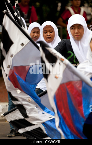 Cheerleaders exercising in the Courtyard of the Istiqlal Mosque in Jakarta, Indonesia Stock Photo