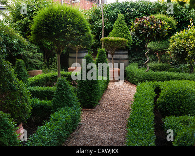 Knot garden parterre with box hedging with gravel path, an attractive compact neat tended designer garden outside English country cottage UK