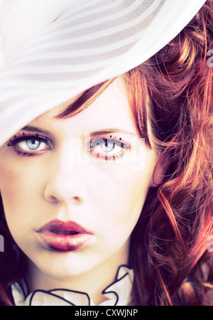 Portrait headshot of a red-haired girl in her early 20s looking youthful and like a doll Stock Photo