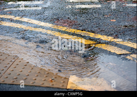 Burst water main pipe flooding road with cars going past Stock Photo ...