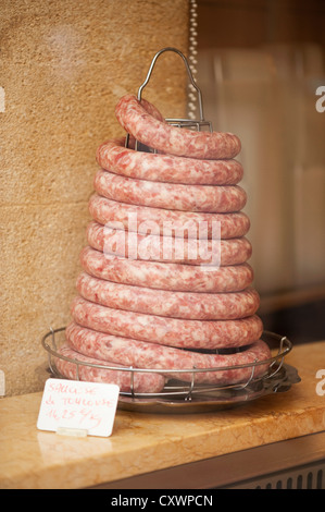 Coiled sausage in butchers shop Stock Photo