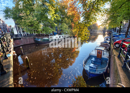A view along one of Amsterdam's many canals early on an Autumn morning Stock Photo