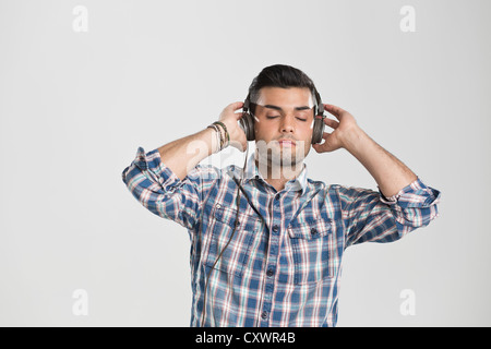 Man listening to headphones Stock Photo