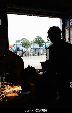 Silhouette of metal worker in shop Stock Photo