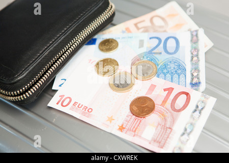 Wallet with euro notes and coins Stock Photo