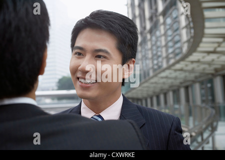 Businessmen talking on walkway Stock Photo