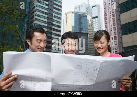 Business people reading blueprints Stock Photo