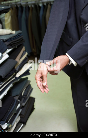 Man fitting business suit in shop Stock Photo