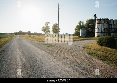 Grain silos on rural gravel road Stock Photo