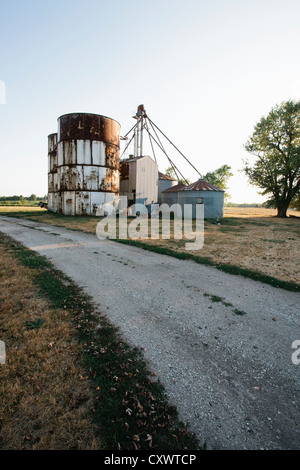 Grain silos on rural gravel road Stock Photo