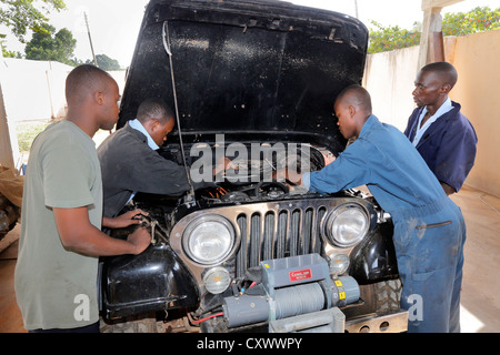 young mechanics works on a car engine. Machui Vocational Center, Machui, Zanzibar, Tanzania