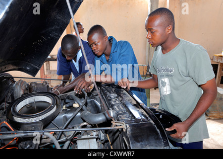 young mechanics works on a car engine. Machui Vocational Center, Machui, Zanzibar, Tanzania