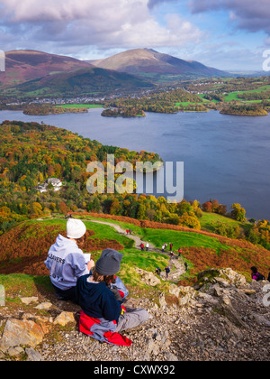 Teenage brother and sister enjoying the view over Derwent Water from Catbells in the Lake District. Keswick, Cumbria Stock Photo