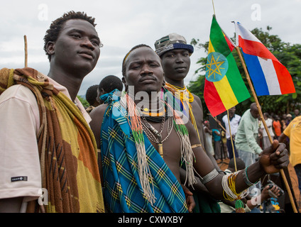 Three Suri (Surma) naked young men body painting with mud, Ethiopia