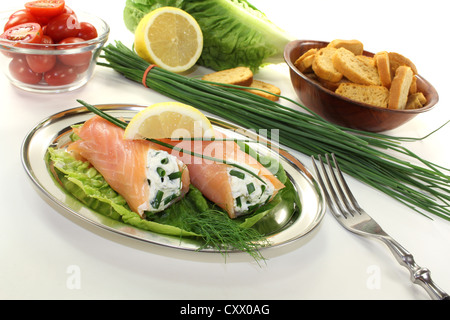 smoked salmon rolls with cream cheese, chives and a lemon slice Stock Photo
