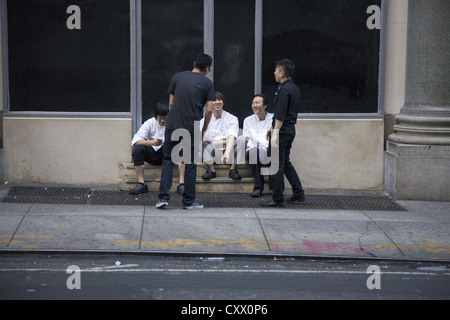 Restaurant workers on break in midtown Manhattan. NYC Stock Photo