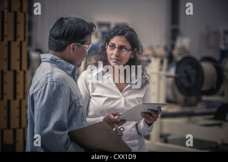 Workers talking in factory Stock Photo