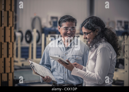 Workers talking in factory Stock Photo
