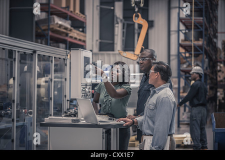 Workers talking in factory Stock Photo