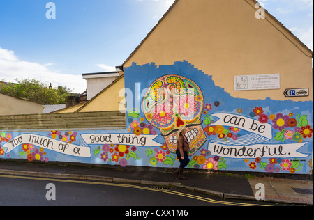 Street art mural on a wall in Glastonbury, Somerset, UK - skull / day of the dead - public art UK Stock Photo