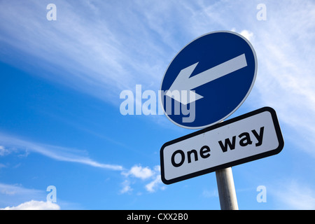 Road sign - One way traffic against blue sky, roads sign UK Stock Photo