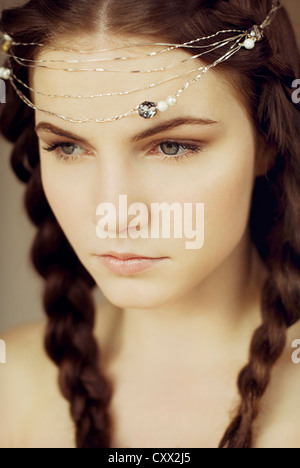 Close portrait of young woman with braids and pearl headpiece Stock Photo