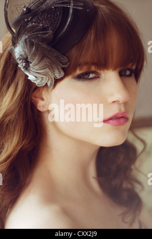 Close portrait of young woman with dramatic eye make-up and hat Stock Photo