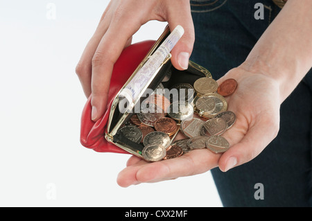 Woman's hand counting cash from her purse Stock Photo