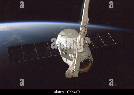 The SpaceX Dragon commercial cargo craft makes an approach to the International Space Station prior to grapple by the station's Canadarm2 robotic arm, controlled by Expedition 33 crew members October 10, 2012. Stock Photo