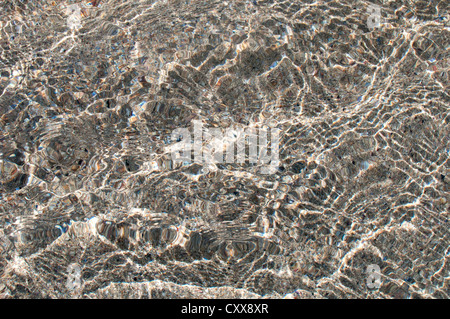 Pattern of reflection and refraction of ripples of seawater on the sandy beach. Stock Photo