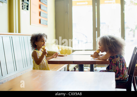 Mixed race girls eating ice cream cones Stock Photo