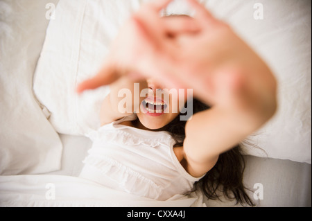 Mixed race girl laying in bed