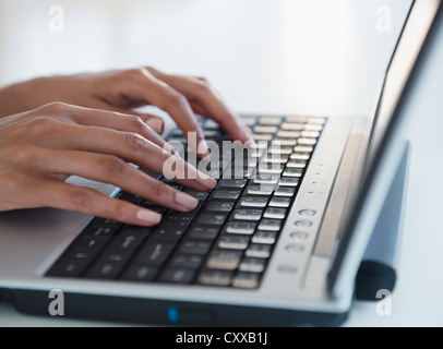 Cape Verdean woman typing on laptop Stock Photo