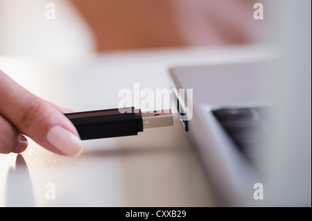 Cape Verdean woman using USB device Stock Photo