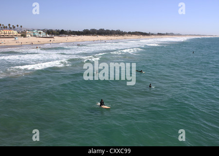 A view of Pismo Beach and surfers in the ocean. Stock Photo